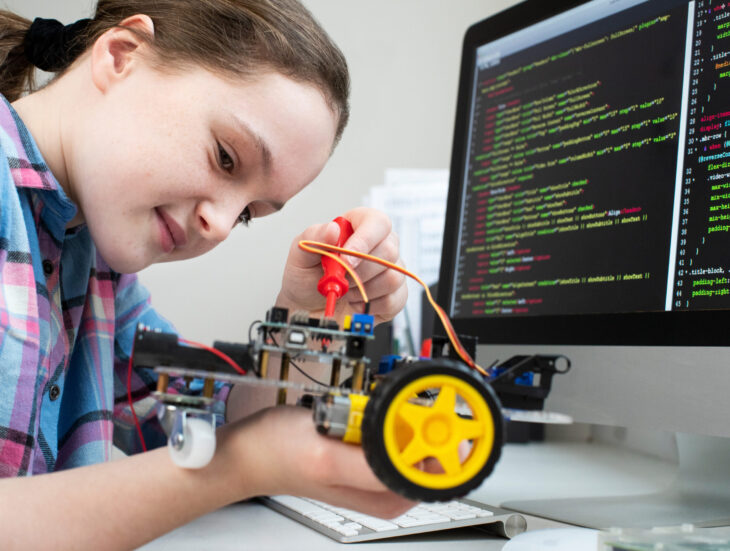 Female Pupil Building Robotic Car In Science Lesson